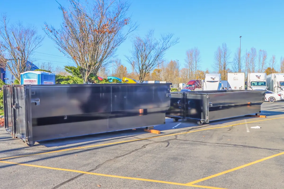 Professional dumpster rental service with roll-off container on residential driveway in Piscataway